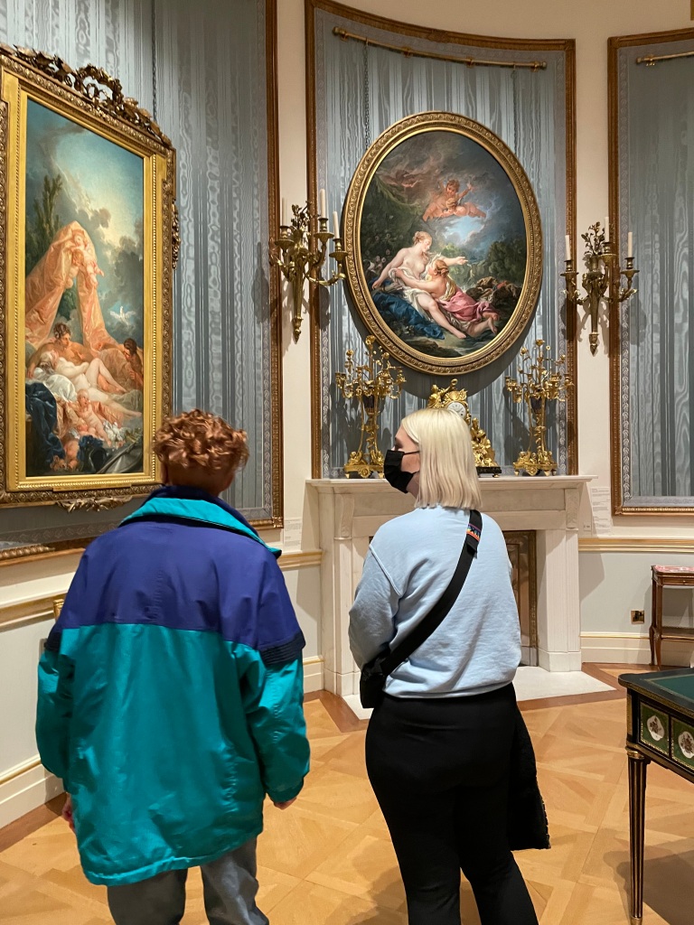 Jess and Jas admire paintings.